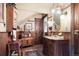 Elegant bathroom with wood trim, a vintage sink, and classic lighting, blending antique charm with modern functionality at 715 Main St, Georgetown, CO 80444