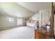 Bright bedroom with sloped ceilings, neutral walls, two windows, and plush carpeting, offering a cozy and airy space at 715 Main St, Georgetown, CO 80444