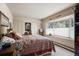 Bright bedroom with a bay window, cozy window seat, plush carpet, and neutral decor, offering a peaceful retreat at 715 Main St, Georgetown, CO 80444