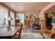 Cozy dining room features a brick fireplace, wood floors, and vintage furnishings at 715 Main St, Georgetown, CO 80444