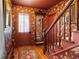 Inviting entryway featuring floral wallpaper, wooden staircase, and a decorative mirror, creating a warm, vintage ambiance at 715 Main St, Georgetown, CO 80444