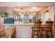 Open kitchen with bar seating and vintage decor, including unique cabinetry and finishes at 715 Main St, Georgetown, CO 80444