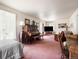 Spacious living room with piano, large TV, and ample seating at 715 Main St, Georgetown, CO 80444