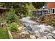 Scenic view of the river flowing through the property, lined with rocks and lush greenery at 715 Main St, Georgetown, CO 80444