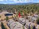 Aerial view of the property featuring mature trees with mountain views and community living at 28110 Meadow Dr, Evergreen, CO 80439