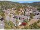 Aerial shot pointing out the property's location in a serene, tree-filled neighborhood with mountain views at 28110 Meadow Dr, Evergreen, CO 80439