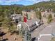 An aerial view showing the home is part of a community surrounded by trees and mountains in the distance at 28110 Meadow Dr, Evergreen, CO 80439