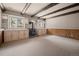 Basement with wood beam ceilings, carpeting, and storage at 28110 Meadow Dr, Evergreen, CO 80439