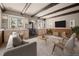 Finished basement with wood beams, wood burning stove, and comfortable seating area at 28110 Meadow Dr, Evergreen, CO 80439