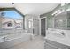 Bright bathroom with soaking tub, glass shower, and double sink vanity at 28110 Meadow Dr, Evergreen, CO 80439