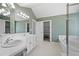 Bathroom featuring a soaking tub, shower, double sink vanity, and decorative wallpaper at 28110 Meadow Dr, Evergreen, CO 80439
