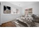 Cozy bedroom featuring a stylish rug, natural light from two windows, and modern wall art at 28110 Meadow Dr, Evergreen, CO 80439