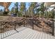 Enjoy mountain views from this spacious deck with black metal railings at 28110 Meadow Dr, Evergreen, CO 80439
