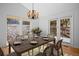 Dining room featuring a stylish chandelier, natural light, and access to an outdoor deck at 28110 Meadow Dr, Evergreen, CO 80439