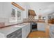 Stylish kitchen boasting stainless steel appliances, tiled backsplash, and wood floors at 28110 Meadow Dr, Evergreen, CO 80439