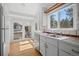 Bright kitchen with stainless steel appliances, offering ample sunlight and a view of the exterior at 28110 Meadow Dr, Evergreen, CO 80439