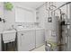 Laundry room featuring a utility sink, washer, dryer, and water heater at 28110 Meadow Dr, Evergreen, CO 80439