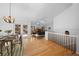 Open-concept living and dining area featuring wood floors, a fireplace and access to an outdoor deck at 28110 Meadow Dr, Evergreen, CO 80439