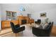 Cozy living room with a fireplace, ceiling fan, and plenty of natural light at 28110 Meadow Dr, Evergreen, CO 80439