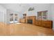 Light-filled living area with wood floors, fireplace, and sliding doors to an outdoor deck at 28110 Meadow Dr, Evergreen, CO 80439