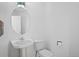 Clean powder room featuring a pedestal sink, toilet, and modern fixtures at 28110 Meadow Dr, Evergreen, CO 80439