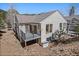 Back exterior displaying a deck with black railings, matched to the beige siding and mountain views at 28110 Meadow Dr, Evergreen, CO 80439