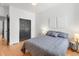 Cozy bedroom showcasing a comfortable bed, dark closet doors, and minimalist decor at 2647 N High St, Denver, CO 80205