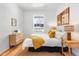 Comfortable bedroom featuring wood floors, white walls, and a view of the neighborhood at 2647 N High St, Denver, CO 80205