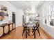 Bright dining room area with chandelier, hardwood floors, and open layout connecting to the kitchen at 2647 N High St, Denver, CO 80205