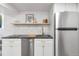 Kitchenette with white cabinets, stainless steel appliances, and butcher block countertops at 2647 N High St, Denver, CO 80205