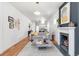 Inviting living room features an open floor plan, fireplace, hardwood floors, and stylish decor at 2647 N High St, Denver, CO 80205