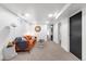 Finished basement area featuring a bright orange sofa and neutral carpet at 2647 N High St, Denver, CO 80205
