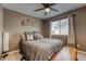 Bedroom featuring a queen bed, window, and neutral decor at 5934 S Yampa St, Aurora, CO 80016