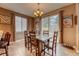 Inviting dining room with a rustic wooden table, chairs, and a sliding glass door to the backyard at 5934 S Yampa St, Aurora, CO 80016