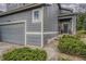 Gray two-story house featuring a well-maintained lawn, stone pathway, and front door decor at 5934 S Yampa St, Aurora, CO 80016