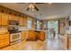 Bright kitchen featuring light wood cabinetry, stainless steel appliances, granite countertops, and tile flooring at 5934 S Yampa St, Aurora, CO 80016