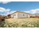 Spacious backyard featuring a well-kept lawn and cozy patio area for outdoor entertaining and relaxation at 2122 Opal Ave, Brighton, CO 80603