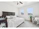 Sun-filled bedroom features plush carpet, a ceiling fan, and large windows for plenty of natural light at 2122 Opal Ave, Brighton, CO 80603
