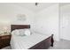 This bedroom features plush carpet, a ceiling fan, and a large window for plenty of natural light at 2122 Opal Ave, Brighton, CO 80603