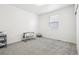 This empty bedroom is ready for your personal touches, featuring a large window and neutral carpet at 2122 Opal Ave, Brighton, CO 80603