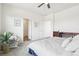 Sun-filled bedroom features plush carpet, a ceiling fan, and large windows for plenty of natural light at 2122 Opal Ave, Brighton, CO 80603