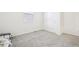 This empty bedroom is ready for your personal touches, featuring a large window and neutral carpet at 2122 Opal Ave, Brighton, CO 80603