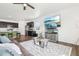 Spacious living room with hardwood floors, open to kitchen and dining area at 2122 Opal Ave, Brighton, CO 80603