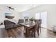 Open-concept dining and living area with wood floors and natural light at 2122 Opal Ave, Brighton, CO 80603