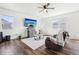 Bright living room with neutral color palette, wood floors, and a large window at 2122 Opal Ave, Brighton, CO 80603