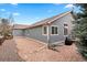 Backyard view of the house showing the low maintenance yard and wood-shingled siding at 1668 Rosemary Dr, Castle Rock, CO 80109