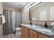 Bathroom with double vanity, granite countertops, and shower/tub combo at 1668 Rosemary Dr, Castle Rock, CO 80109