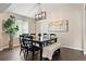 Dining room features a modern chandelier, large window and comfortable bench seating at 1668 Rosemary Dr, Castle Rock, CO 80109