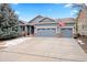 Charming two-story home featuring a well-manicured front yard and an attached two-car garage at 1668 Rosemary Dr, Castle Rock, CO 80109