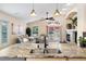 Open floor plan from kitchen featuring granite island to living room with fireplace and outdoor access at 1668 Rosemary Dr, Castle Rock, CO 80109